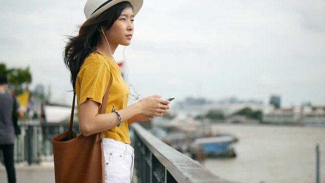 Young asian woman using smartphone take photo around chao phraya river. Beautiful asian girl tourist travel to thailand.