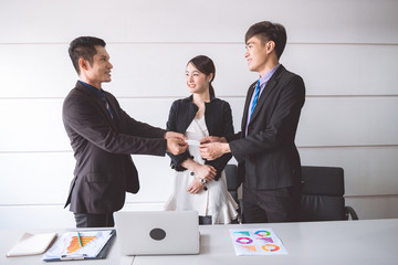 Young businessman giving name card to his customer.