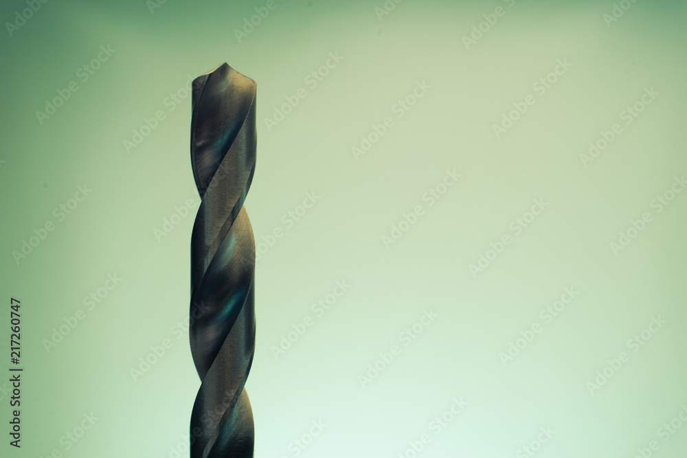 Poster Metal drill bit rotation on a dark background. Macro view.