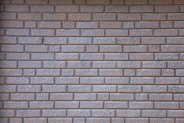 Grey brick wall background and texture in bright day.
