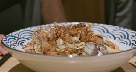 Woman eating fried Japanese udon in restaurant