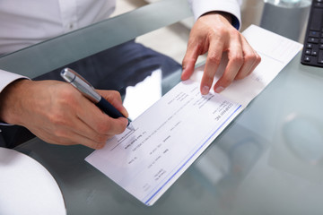 Businessman Signing Cheque