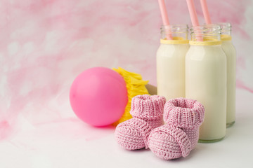 Idea decoration for baby shower party on table. Milk bottles and ballons, waiting for a baby girl