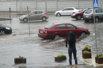 People on a rainy day in the city. Flooding after heavy rain,