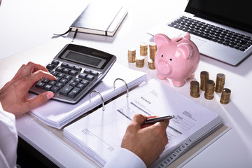 Businessman Calculating Invoice