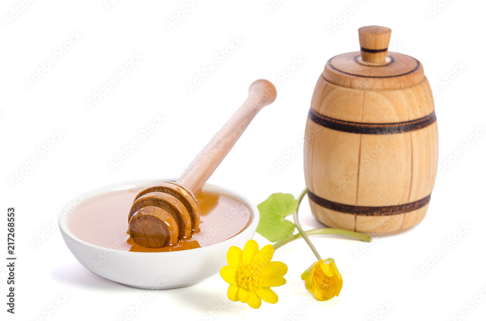 Wall mural honey in the glass bowl with dipper isolated on white background