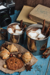 Metal mugs with cacao and marshmallows, still life