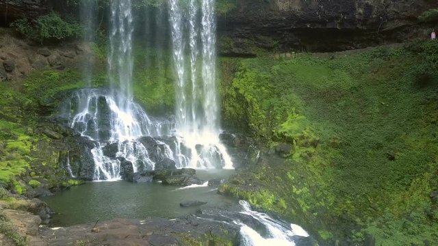 waterfall cascade and brown stones on foreground