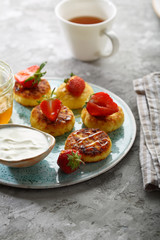 Breakfast pancakes with cream and cup of tea
