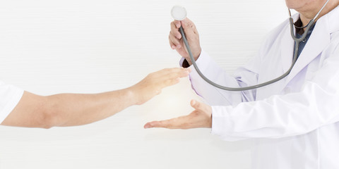 Portrait of old doctor man.Hand holding stethoscopes to health check on white background.Copy space.