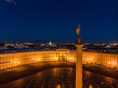 Aerial front view at the General staff and arc de Triomphe building in white nights, exterior Palace Square and Aleksandr Column at summer. Top view from drone. Saint-Petersburg, Russia