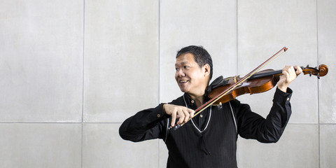 Musician playing violin in livingroom relax time.Copy space. © Suthiporn