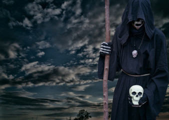 Grim reaper on a dark night sky
