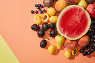 top view of various fresh ripe sweet fruits on red background