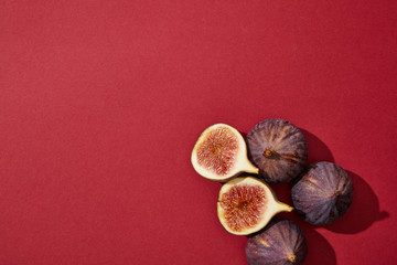 top view of fresh ripe healthy figs on red background