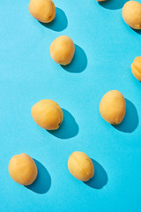 top view of fresh ripe sweet apricots on blue background