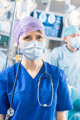 Portrait of the Professional Nurse / Medical Assistant  Taking off Surgical Mask after Successful...