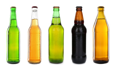 Different bottles with fresh beer on white background