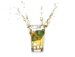 Glass of splashing lemonade with citrus fruit on white background
