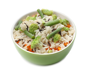 Bowl with tasty boiled rice and vegetables on white background