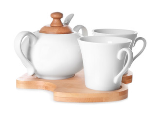 Set of cups with sugar bowl on white background