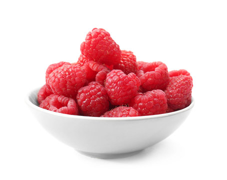Bowl with fresh ripe raspberries on white background