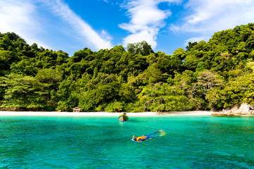 Tourist woman snorkeling in tropical island in Thailand.