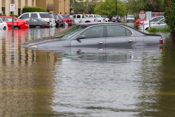 Cars submerged  in Houston, Texas, US during hurricane Harvey. Water could enter the engine,...