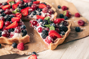 Delicious pie with ripe berries on table, closeup