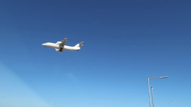 driving on freeway with plane overhead in car view