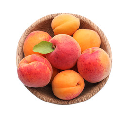 Bowl with ripe sweet apricots on white background