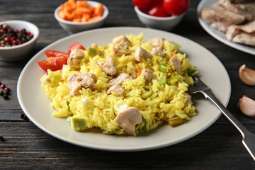 Delicious rice with meat and vegetables on plate