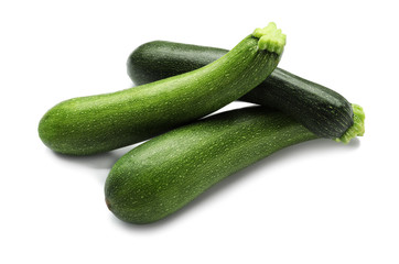 Ripe zucchinis on white background