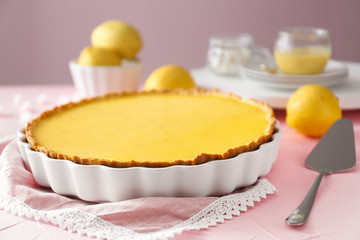 Tasty lemon pie on table