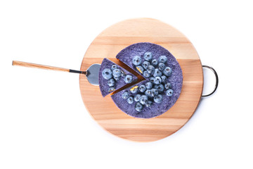 Board with tasty blueberry cheesecake on white background
