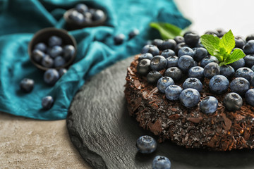 Delicious blueberry chocolate cake on slate plate
