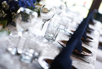 Close-up of folded napkin and empty glasses