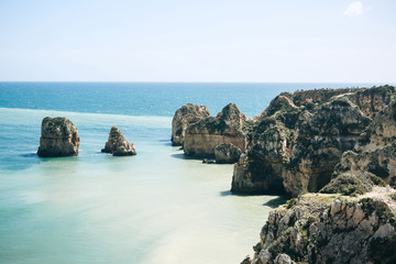 Fototapeta premium Beautiful views of the Atlantic Ocean and the rocks off the coast of Portugal next to the city called Lagos. Amazing natural landscape.