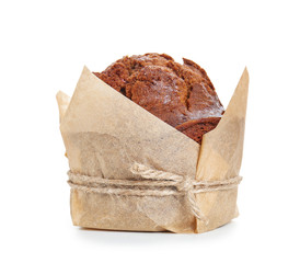 Sweet tasty muffin wrapped in paper on white background
