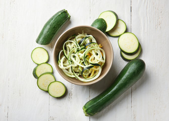 Composition with zucchini spaghetti on table, top view