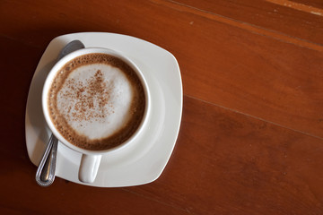 Top view of a cup of mocha on the wooden table.