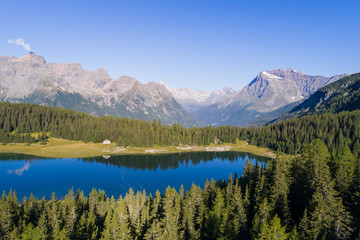 Fototapeta na wymiar Valmalenco, Palù lake. Alpine lake and forest in the Alps