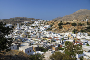 Fototapeta na wymiar Beautiful panoramic view of Lindos with white roofs and blue sky (Rhodes, Greece)