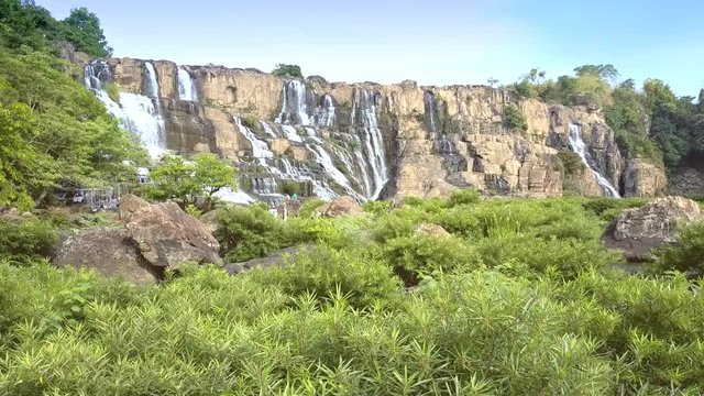 motion to Pongour waterfall above river brushwoods