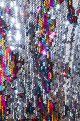 sequins colorful on the fabric. Texture scales of round sequins 