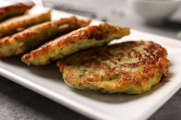 Plate with zucchini pancakes, closeup