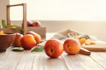 Fresh sweet peaches on wooden table