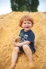Boy playing on yellow sand