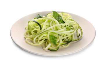 Plate with zucchini spaghetti isolated on white