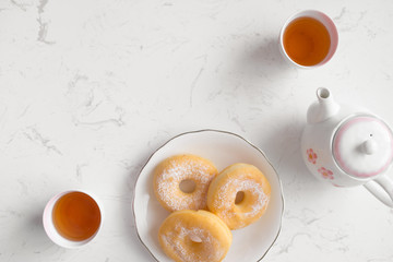Classic donut. Morning breakfast with tea on table in living room at home.